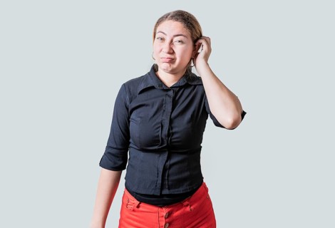 Person scratching head with indecisive expression isolated. Cute woman scratching her head with