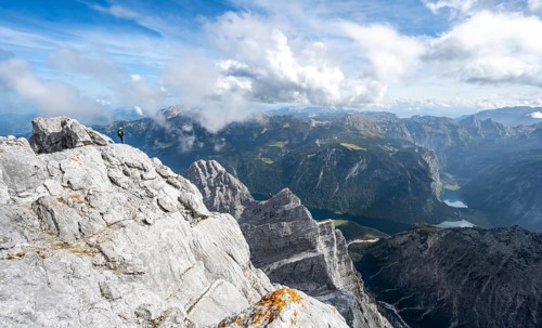 Mountaineer on the rocky summit of the Watzmann Mittelspitze, Watzmann crossing, view of mountain