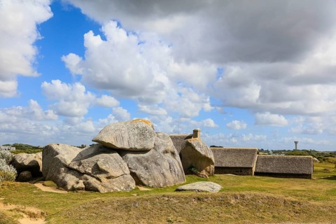 Former village of Meneham on the Atlantic coast with partly thatched houses between granite rocks,