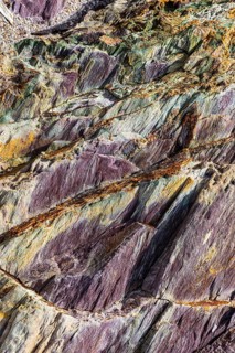 Coloured, ferrous mineral rocks on the beach of Topinetti, near Rio Marina, Elba, Tuscan