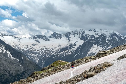 Mountaineer on hiking trail with snow, Berliner Hoehenweg, mountain landscape with glaciated peaks