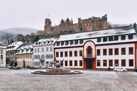 Heidelberg, Germany, February 2020: Town square called 'Karlsplatz' with snow in winter in historic