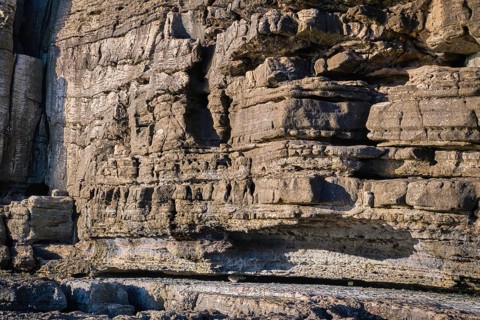 Beautiful texture of cliffs and rock formations in Peniche, Portugal, on sunny day. Weathered rock
