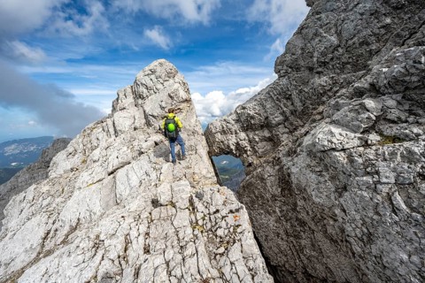 Mountaineer on a narrow rocky ridge, Watzmann crossing to Watzmann Mittelspitze, view of mountain