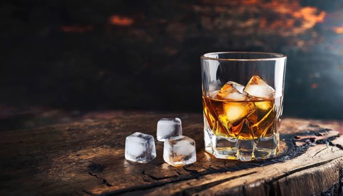 Whiskey with rocks or ice cubes in a glass with ice in a dark wooden background. AI Generated, AI