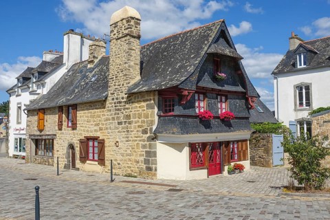 Rue du General de Gaulle in the old town centre of Le Faou with slate-roofed granite houses from