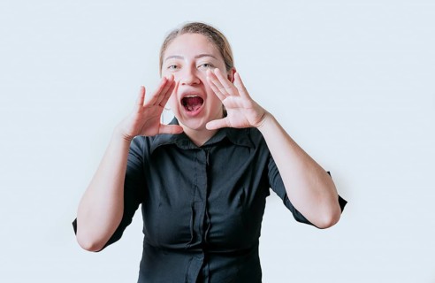 Female teenager announcing something to the camera. Young girl screaming and announcing at the