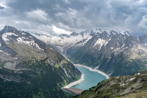 Mountain landscape, view of Schlegeis reservoir with dam wall, glaciated rocky mountain peaks Hoher