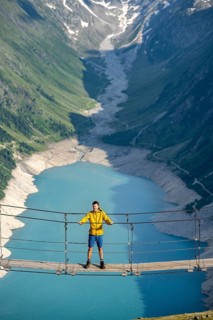 Mountaineers on a suspension bridge, picturesque mountain landscape near the Olpererhuette, view of