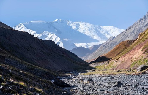 Valley with river Achik Tash between high mountains, mountain landscape with peak Pik Lenin, Osh
