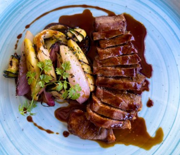 Elegant Plate with Sliced Beef Entrecote Steak with Potatoes and Seasonal Vegetables and Brown