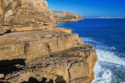 Beautiful cliffs and rock formations in Peniche, Portugal, on sunny day. Weathered rock formations,