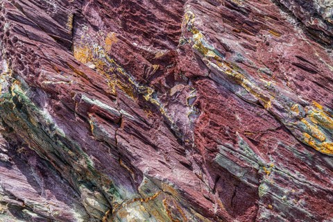 Coloured, ferrous mineral rocks on the beach of Topinetti, near Rio Marina, Elba, Tuscan