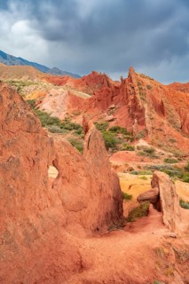 Eroded mountain landscape, sandstone cliffs, canyon with red and orange rock formations, Konorchek