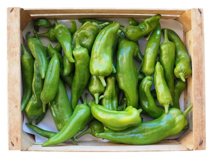 Green peppers in crate isolated over white