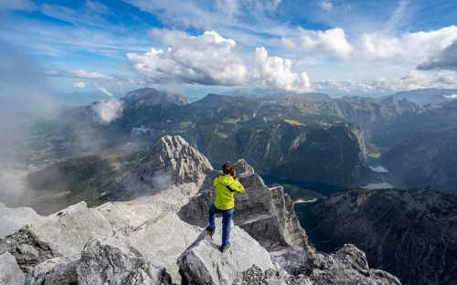 Mountaineer on the rocky summit of the Watzmann Mittelspitze, Watzmann crossing, view of mountain