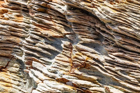 Coloured, ferruginous mineral sandstone on Topinetti beach, near Rio Marina, Elba, Tuscan