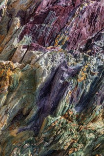 Coloured, ferrous mineral rocks on the beach of Topinetti, near Rio Marina, Elba, Tuscan