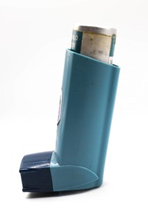 Asthmatic inhaler isolated. Medical asthma inhaler with cap on isolated background