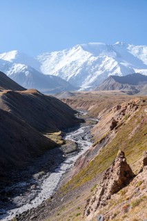 Valley with river Achik Tash between high mountains, mountain landscape with peak Pik Lenin, Osh