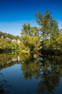 River with gorge and autumnal coloured forest, valley of the Loue, Lizine, near Besancon,