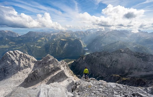 Mountaineer on the rocky summit of the Watzmann Mittelspitze, Watzmann crossing, view of mountain