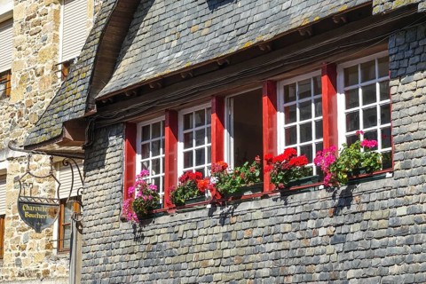 Rue du General de Gaulle in the old town centre of Le Faou with slate-roofed granite houses from