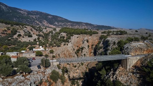 Metal bridge over a gorge with parked cars and mountain backdrop, Aradena Gorge, Aradena, Sfakia,