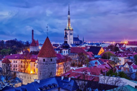Aerial view of Tallinn Medieval Old Town with St. Olaf's Church and Tallinn City Wall illuminated