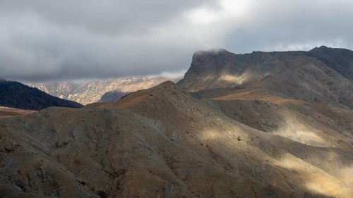 Low hanging clouds in the mountain landscape at the Tizi-n-Tichka pass road, High Atlas, Morocco,