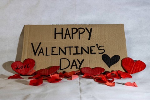 Cardboard sign Happy Valentine's Day isolated. Text of Happy Valentine's Day written on a cardboard