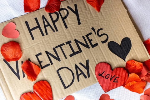 Cardboard sign Happy Valentine's Day isolated. Text of Happy Valentine's Day written on a cardboard