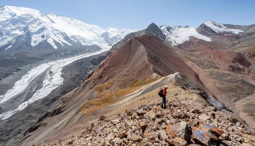 Mountaineer at Traveller's Pass with view of impressive mountain landscape, high mountain landscape