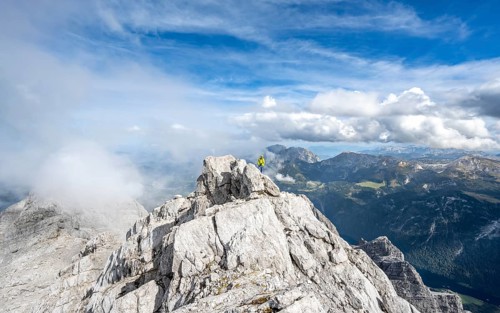 Mountaineer on the rocky summit of the Watzmann Mittelspitze, Watzmann crossing, view of mountain