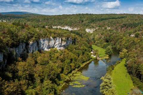 River with gorge and autumnal coloured forest, valley of the Loue, Lizine, near Besancon,
