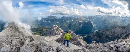 Mountaineer on the rocky summit of the Watzmann Mittelspitze, Watzmann crossing, view of mountain