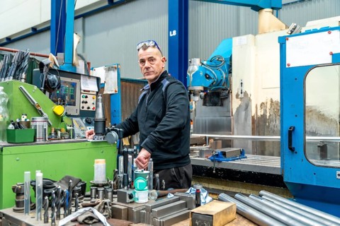 Photo with copy space of an engineer working using a cnc machine in a logistics factory