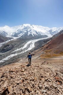 Mountaineer at Traveller's Pass with view of impressive mountain landscape, high mountain landscape