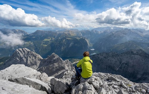 Mountaineer on the rocky summit of the Watzmann Mittelspitze, Watzmann crossing, view of mountain