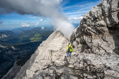 Mountaineer on a narrow rocky ridge, Watzmann crossing to Watzmann Mittelspitze, view of mountain