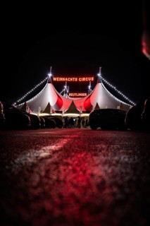 People in front of the illuminated 'Christmas Circus' tent at night, Reutlingen, Germany, Europe