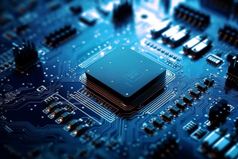 Close-up image of a blue circuit board with a central microchip processor CPU with various