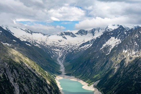 Mountain landscape, view of turquoise-blue lake Schlegeisspeicher, glaciated rocky mountain peaks