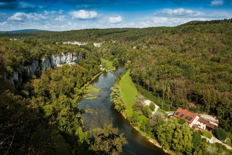 River with gorge and autumnal coloured forest, valley of the Loue, Lizine, near Besancon,