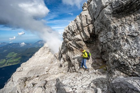 Mountaineer on a narrow rocky ridge, Watzmann crossing to Watzmann Mittelspitze, view of mountain