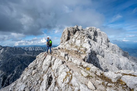 Mountaineer on a narrow rocky ridge, Watzmann crossing to the Watzmann Mittelspitze, Berchtesgaden