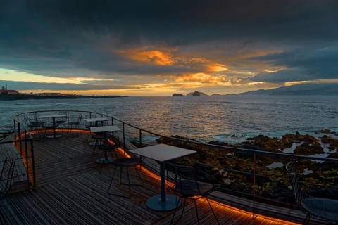 Terrace of the Cella Bar overlooking the coast of Madalena and the distant island of Faial at
