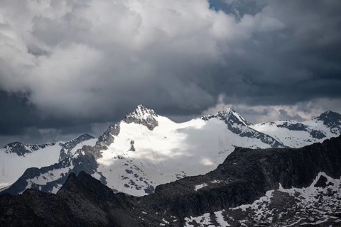 Glaciated rocky mountain peaks, Hornspitze summit, dramatic cloudy sky, Zillertal Alps, Tyrol,