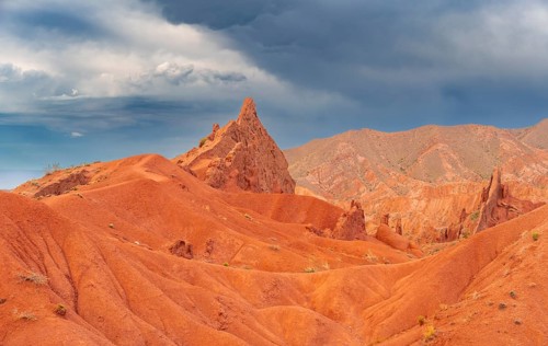 Eroded mountain landscape, sandstone cliffs, canyon with red and orange rock formations, Konorchek