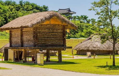 Buyeo, South Korea, July 7, 2018:Large log building with straw thatch roof elevated off ground in